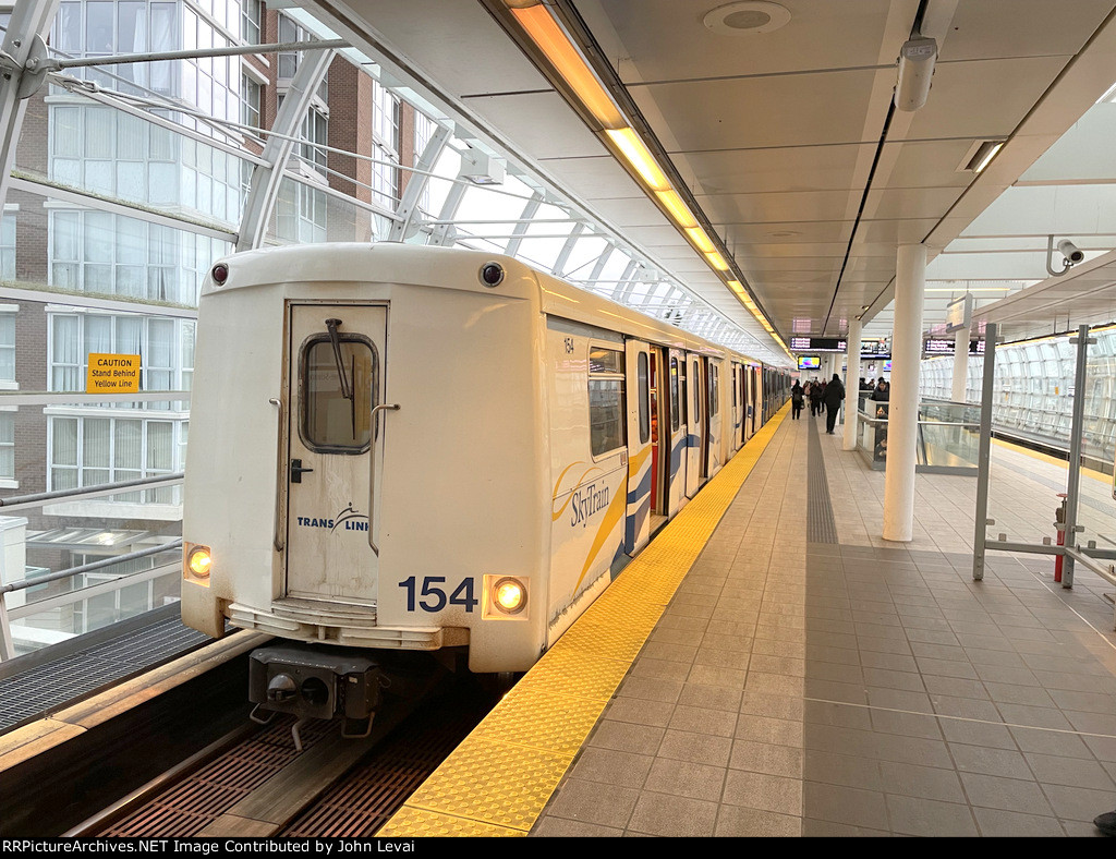 A train of the older Mark Series Cars arrives at Main Street-Science World Station heading to the Waterfront Station